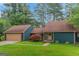 Charming home with a two-car garage, complemented by a well-manicured lawn and vibrant shrubbery at 959 Sweet Briar Se Trl, Conyers, GA 30094