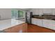 Modern kitchen featuring stainless steel appliances, a white island, and a window with a lush view at 959 Sweet Briar Se Trl, Conyers, GA 30094