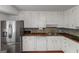 Modern kitchen featuring stainless steel appliances, a white island, and butcher block countertops at 959 Sweet Briar Se Trl, Conyers, GA 30094
