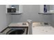 Well-equipped laundry area with modern washer and dryer appliances and overhead storage at 959 Sweet Briar Se Trl, Conyers, GA 30094