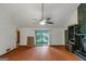 Bright living room featuring vaulted ceilings, a ceiling fan, and sliding glass doors at 959 Sweet Briar Se Trl, Conyers, GA 30094