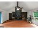 Spacious living room with a cozy stone fireplace, built-in bookshelves, and sliding doors at 959 Sweet Briar Se Trl, Conyers, GA 30094