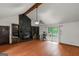 Spacious living room with a cozy stone fireplace, built-in bookshelves, and sliding doors at 959 Sweet Briar Se Trl, Conyers, GA 30094