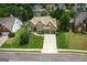 Overhead view of a home with lush landscaping and a long driveway in a tree-lined neighborhood at 1511 Rocky Knoll Ln, Dacula, GA 30019
