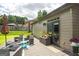 Outdoor back patio area featuring wicker furniture, an umbrella, and a privacy fence at 1511 Rocky Knoll Ln, Dacula, GA 30019