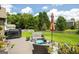 Backyard featuring a patio set, grill, and green grass with mature trees at 1511 Rocky Knoll Ln, Dacula, GA 30019