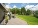 Outdoor patio area featuring wicker furniture, landscaping, and green grass at 1511 Rocky Knoll Ln, Dacula, GA 30019