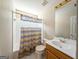 Bathroom with shower and tub, colorful shower curtain, toilet, vanity and sink at 1511 Rocky Knoll Ln, Dacula, GA 30019
