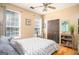 Cozy bedroom featuring a large window, ceiling fan, and a comfortable queen bed at 1511 Rocky Knoll Ln, Dacula, GA 30019