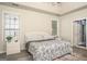 Bedroom featuring a queen bed, neutral walls, and two windows for natural light at 1511 Rocky Knoll Ln, Dacula, GA 30019