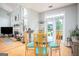 Open dining area featuring a glass table, backyard views, and hardwood floors at 1511 Rocky Knoll Ln, Dacula, GA 30019