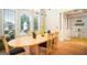 Bright dining area with large windows, a modern chandelier, and hardwood floors at 1511 Rocky Knoll Ln, Dacula, GA 30019