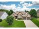 Beautiful home with an inviting façade, lush green lawn, and ample parking space in the driveway at 1511 Rocky Knoll Ln, Dacula, GA 30019
