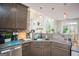 Well-lit kitchen featuring granite countertops, stainless steel appliances and eating area in open floor plan at 1511 Rocky Knoll Ln, Dacula, GA 30019
