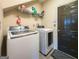 Functional laundry room with modern Samsung washer and dryer and storage shelves at 1511 Rocky Knoll Ln, Dacula, GA 30019