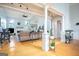 Bright and spacious living room with hardwood floors, columns, and a cozy seating area at 1511 Rocky Knoll Ln, Dacula, GA 30019