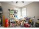 An organized room with ceiling fan, windows, shelving and tables with storage items at 1511 Rocky Knoll Ln, Dacula, GA 30019