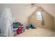Attic room featuring a window, vaulted ceilings, and carpeted floors for a comfortable living space at 1511 Rocky Knoll Ln, Dacula, GA 30019
