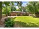 Spacious backyard with a deck, lush lawn, and beautiful flowers, perfect for outdoor activities at 2163 Medfield Ne Trl, Chamblee, GA 30345