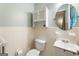 Cozy bathroom featuring a toilet, wall sink, and mirrored medicine cabinet at 2163 Medfield Ne Trl, Chamblee, GA 30345