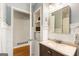 Charming bathroom view showcasing built-in shelves, tile flooring, and a vanity with storage at 2163 Medfield Ne Trl, Chamblee, GA 30345