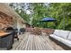 Beautiful wooden deck, perfect for entertaining, with outdoor furniture and a view of the surrounding trees at 2163 Medfield Ne Trl, Chamblee, GA 30345