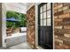 Inviting entryway with a black front door and partial view of the outdoor patio area at 2163 Medfield Ne Trl, Chamblee, GA 30345
