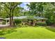 Charming brick home featuring a well-manicured lawn and lush landscaping, creating inviting curb appeal at 2163 Medfield Ne Trl, Chamblee, GA 30345