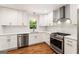 Modern kitchen with stainless steel appliances, white cabinets, and hardwood floors offering a stylish cooking space at 2163 Medfield Ne Trl, Chamblee, GA 30345