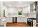 Modern kitchen with white cabinets, stainless steel appliances, and hardwood flooring at 2163 Medfield Ne Trl, Chamblee, GA 30345