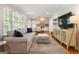 Bright living room with a comfortable sofa, ottoman, and stylish accents, flowing into dining area at 2163 Medfield Ne Trl, Chamblee, GA 30345