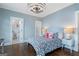 Cozy bedroom with a decorative chandelier, patterned bedding, and an en suite bathroom at 785 Wilson Nw Rd, Atlanta, GA 30318