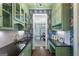 Butler's pantry with custom cabinets, stylish wallpaper, wine refrigerator and hardwood floors at 785 Wilson Nw Rd, Atlanta, GA 30318