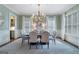 Elegant dining room with stylish chandelier, plantation shutters and designer rug at 785 Wilson Nw Rd, Atlanta, GA 30318