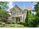 Charming two-story home with gray wood shingle siding, manicured landscaping and inviting front porch at 785 Wilson Nw Rd, Atlanta, GA 30318