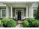 Inviting front porch with stone walkway, stately columns and covered entry with seating at 785 Wilson Nw Rd, Atlanta, GA 30318