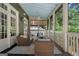 Relaxing screened-in porch with comfortable seating, ceiling fan, and wooded views at 785 Wilson Nw Rd, Atlanta, GA 30318