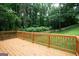 Large backyard deck overlooking a spacious lawn and lush greenery, perfect for outdoor entertaining at 1258 Campbellton Sw Rd, Atlanta, GA 30310