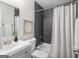 Bathroom with gray tiled shower, tub, modern vanity, and decorative artwork at 1258 Campbellton Sw Rd, Atlanta, GA 30310