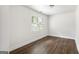Bright bedroom with wood-look tile flooring, white walls, and a large window offering natural light at 1258 Campbellton Sw Rd, Atlanta, GA 30310