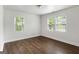 Bright bedroom with wood-look tile flooring, white walls, and two windows offering natural light at 1258 Campbellton Sw Rd, Atlanta, GA 30310