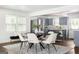 Stylish dining area featuring modern seating and sleek finishes, seamlessly connected to the kitchen with stainless steel appliances at 1258 Campbellton Sw Rd, Atlanta, GA 30310