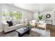 Inviting living space with hardwood floors and a decorative rug, complemented by neutral furnishings and natural light at 1258 Campbellton Sw Rd, Atlanta, GA 30310