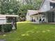 Lush backyard with a covered patio, shed, and well-maintained lawn at 149 Crown Oaks Dr, Stockbridge, GA 30281