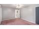 Empty bedroom with a ceiling fan and access to the bathroom and closet at 149 Crown Oaks Dr, Stockbridge, GA 30281