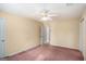 Bedroom with a ceiling fan and neutral walls, doorway to bathroom at 149 Crown Oaks Dr, Stockbridge, GA 30281