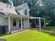 Lovely home featuring a covered porch with rocking chairs overlooking the spacious backyard and wooded area at 149 Crown Oaks Dr, Stockbridge, GA 30281