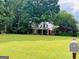 Traditional home exterior featuring a well-manicured lawn and a classic mailbox at 149 Crown Oaks Dr, Stockbridge, GA 30281