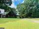 View of a home, surrounded by lush greenery and a sprawling lawn at 149 Crown Oaks Dr, Stockbridge, GA 30281