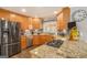 Modern kitchen with stainless steel appliances, granite countertops, and wood cabinets offering ample storage at 149 Crown Oaks Dr, Stockbridge, GA 30281